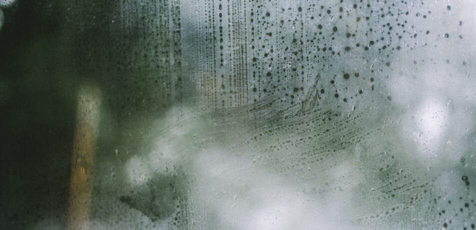 Up close image of a fogged window caused by trapped condensation.