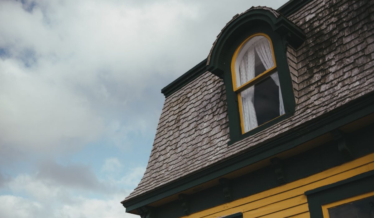 An older home with roof discoloration. A roof inspection can help diagnose the issue.
