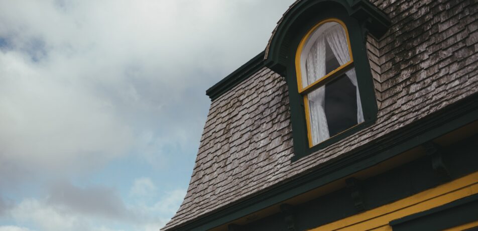 An older home with roof discoloration. A roof inspection can help diagnose the issue.