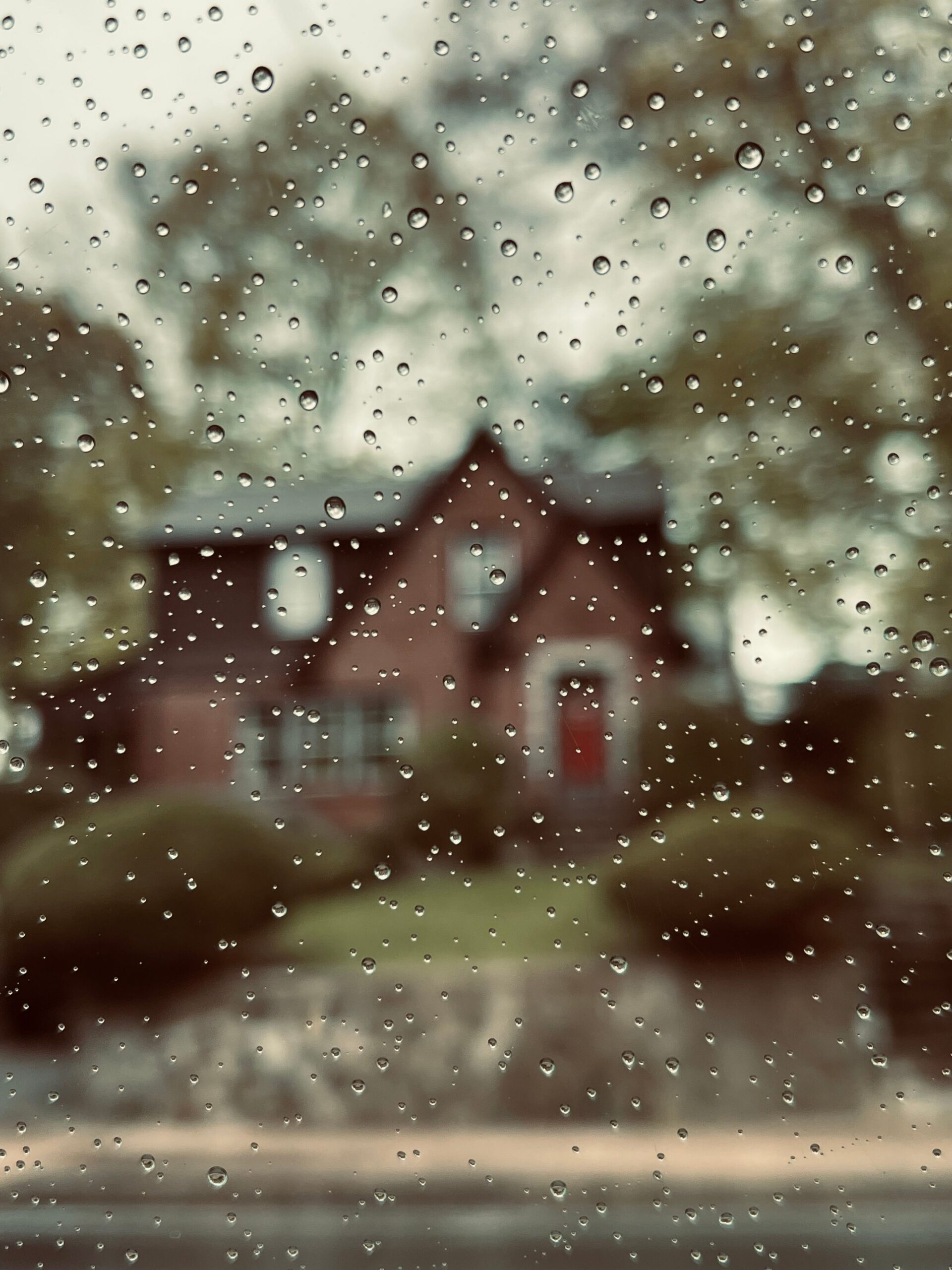 A house outside of a fogged window, which can be sign of excess moisture in a home...and the beginning of a musty scent.